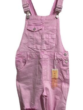 Risen Pink Denim Overalls. Distressed acid wash with raw hem.